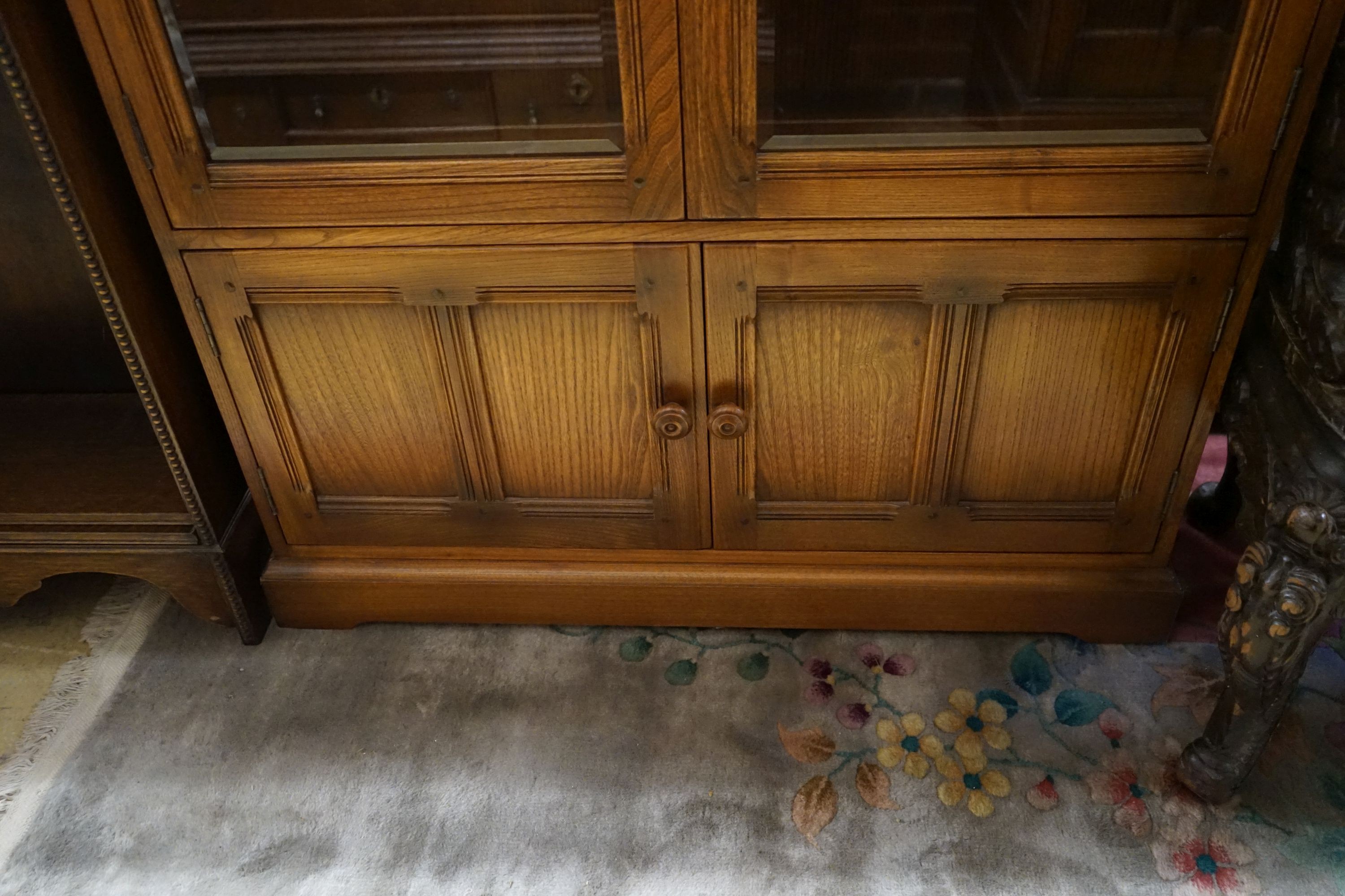 An Ercol elm bookcase, length 101cm, depth 30cm, height 137cm